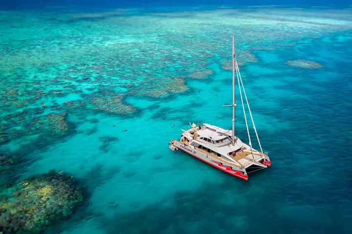 Sailing catamaran over the outer reef off Cairns